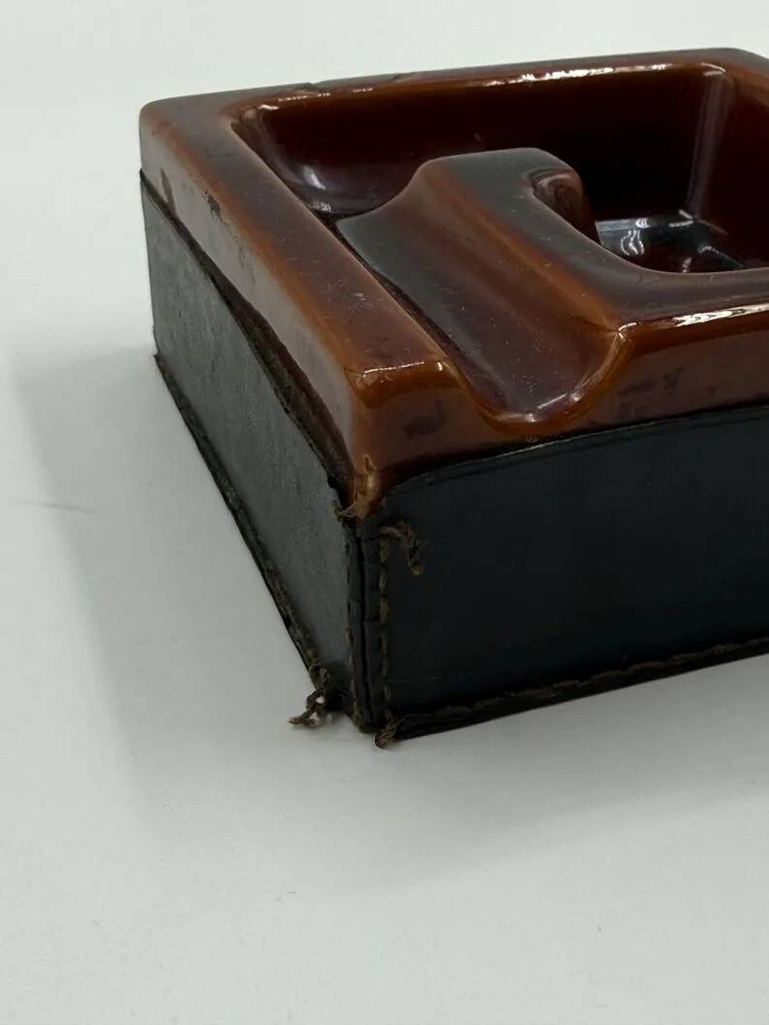 Geometric brown enamelled ashtray with a leather base (1960s-70s)