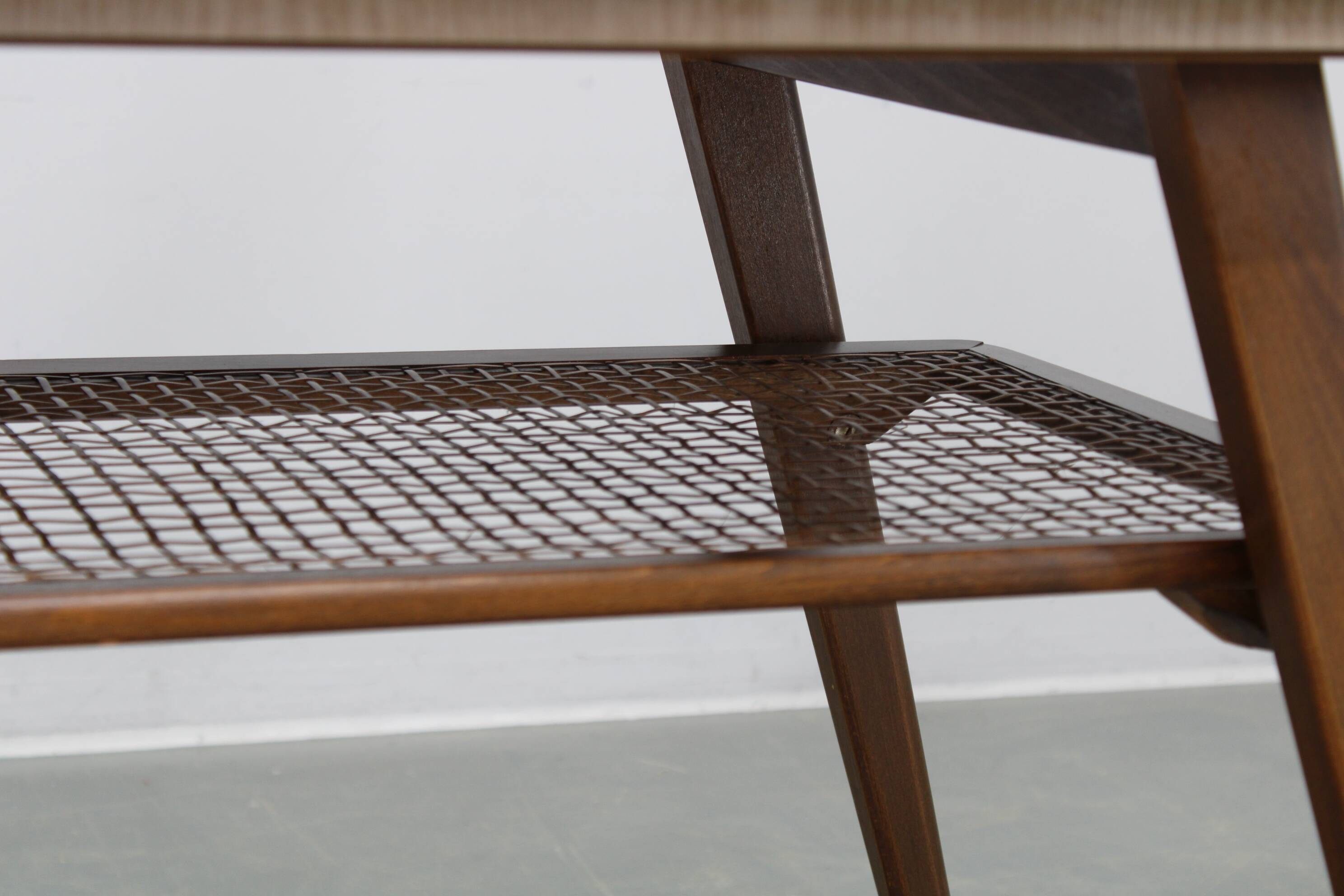 Mid-century German coffee table with rattan shelf and brass legs