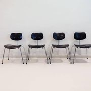Set of four Egon Eiermann model SE 68 chairs in black lacquered plywood and steel.