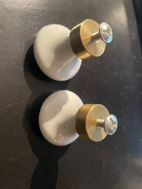 a pair of small antique porcelain and brass knob handles