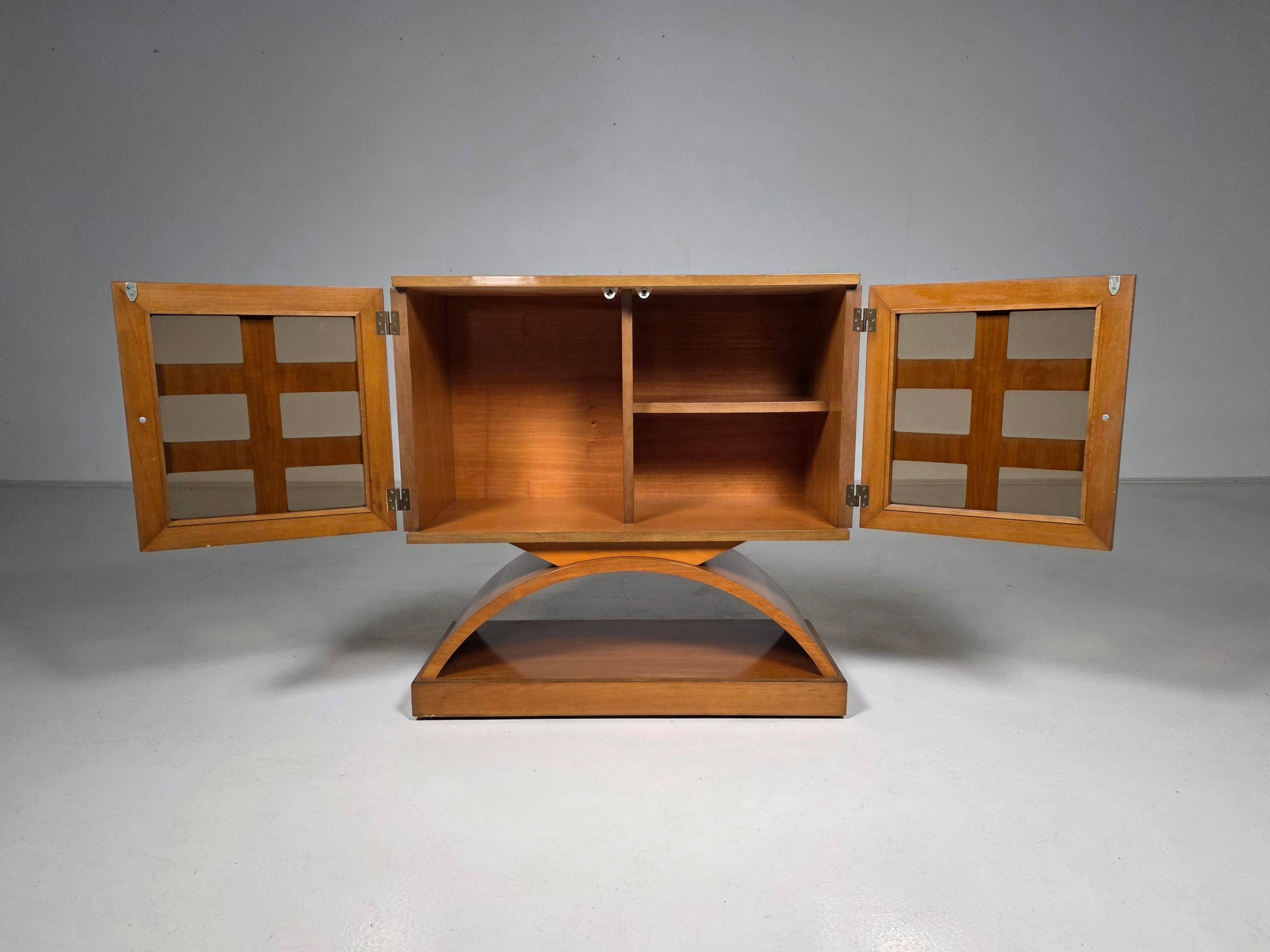 Mid-century modern mobile bar cabinet with sculptural base, 1950s.