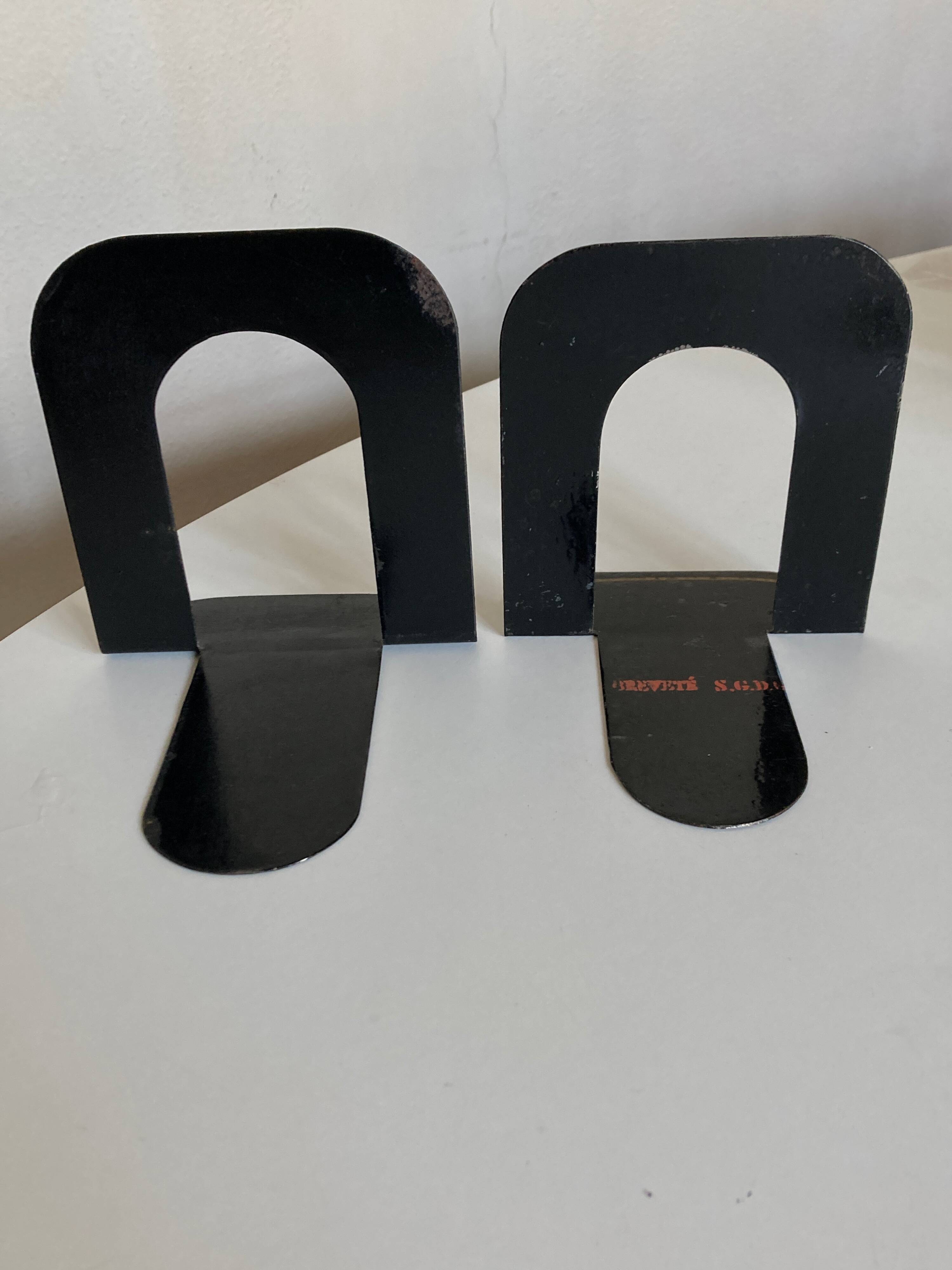 Pair of heavy metal bookends, folded, 1920.