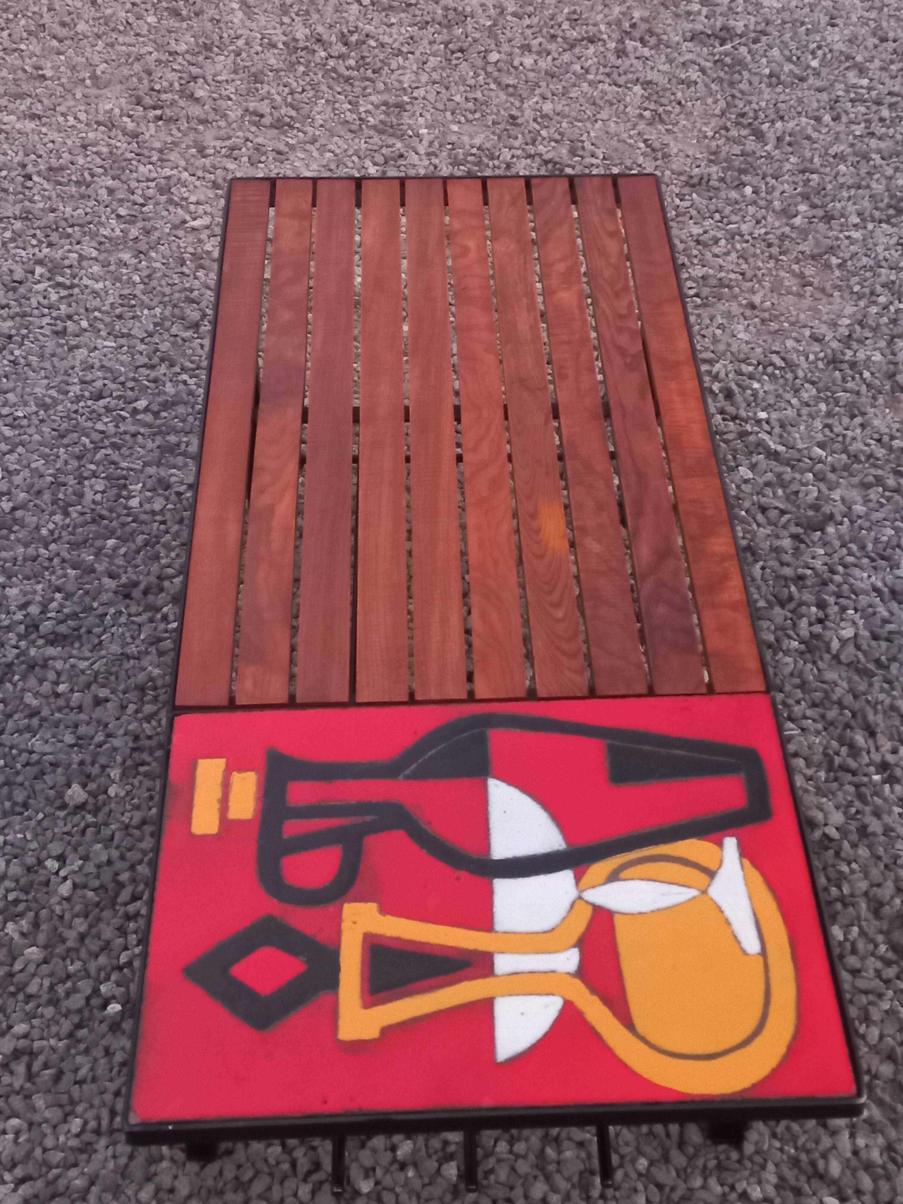 1970s design coffee table with ceramic and wood top, metal legs.