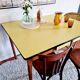 Old wooden farmhouse table and yellow formica top