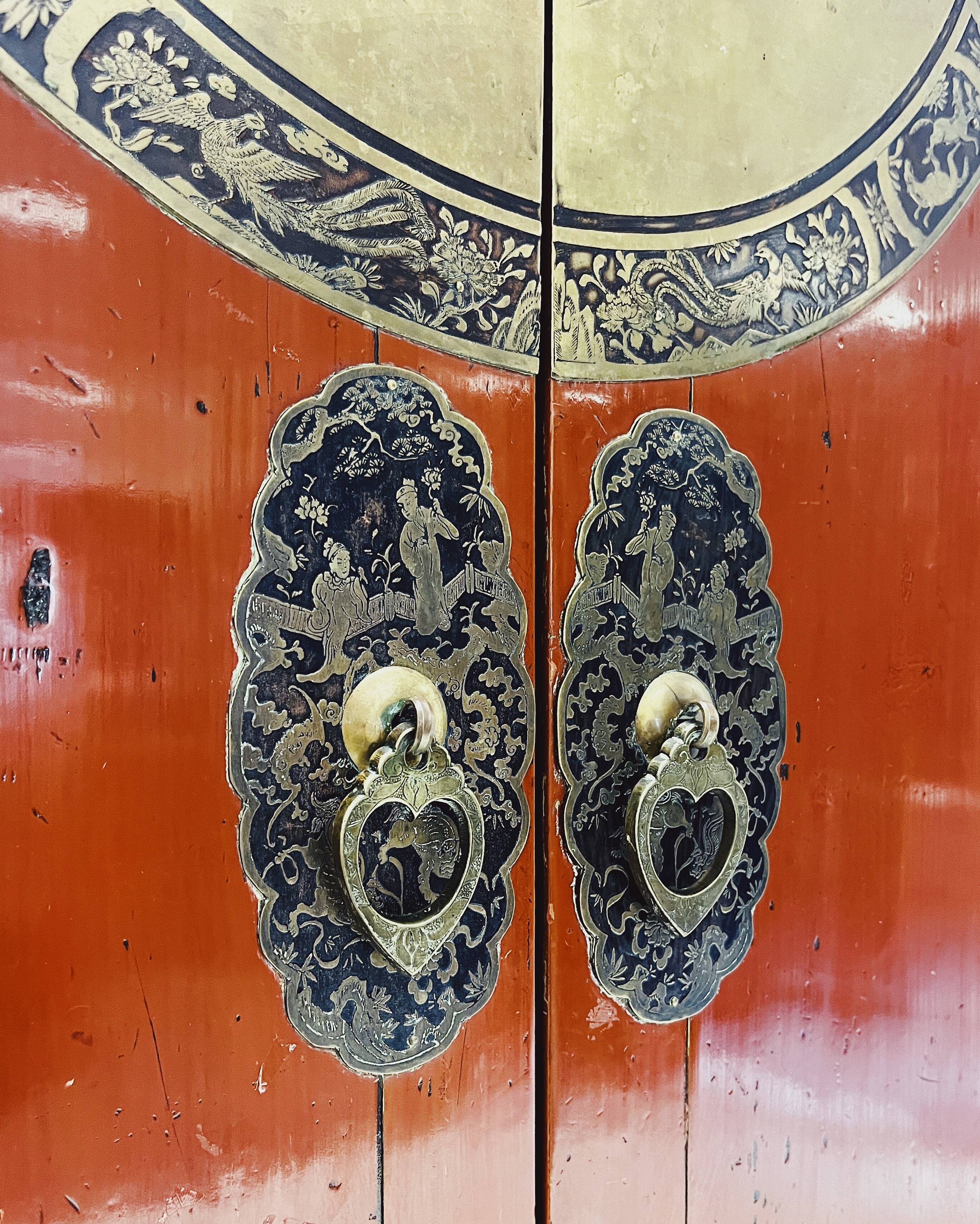 Antique red cabinet with brass details
