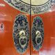 Antique red cabinet with brass details