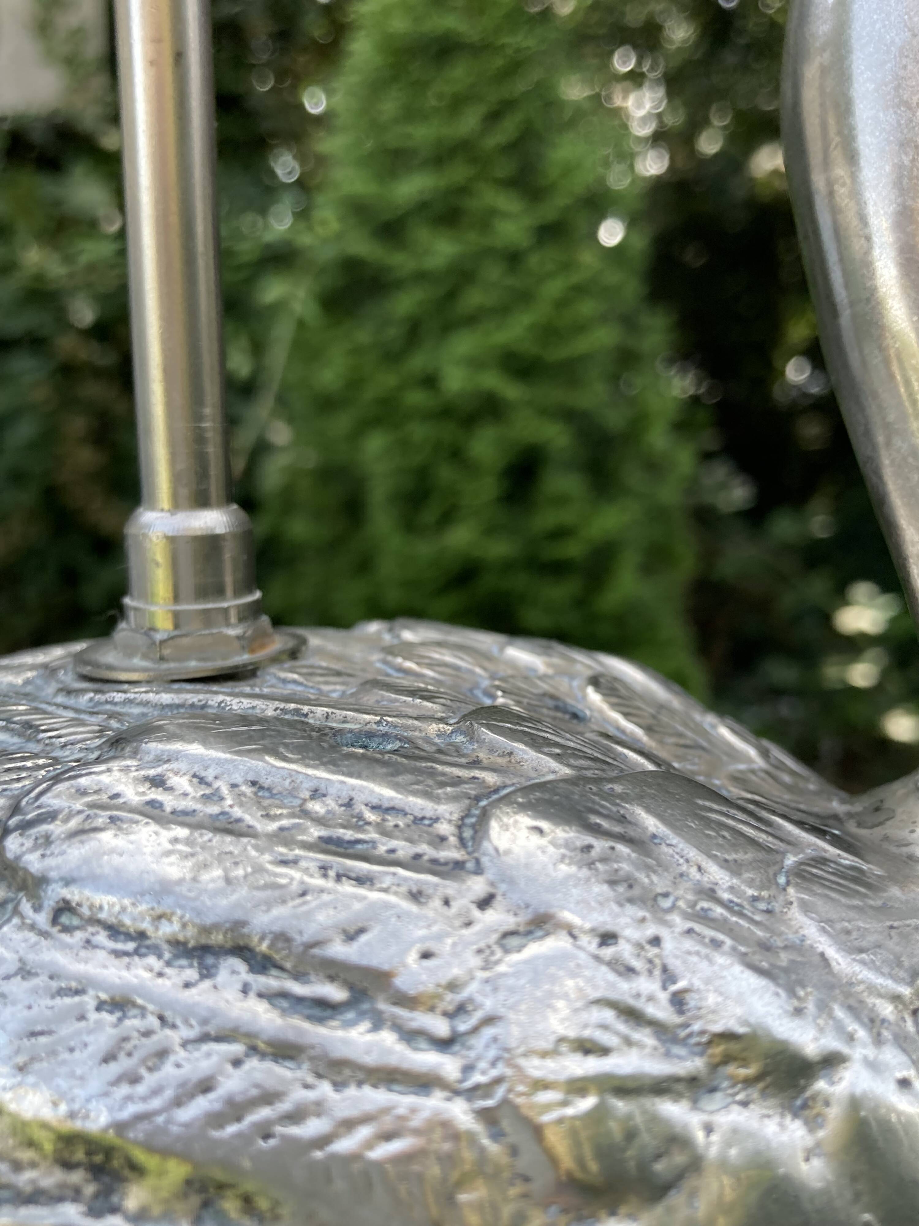 Old vintage lamp representing a duck in silver metal with wooden base