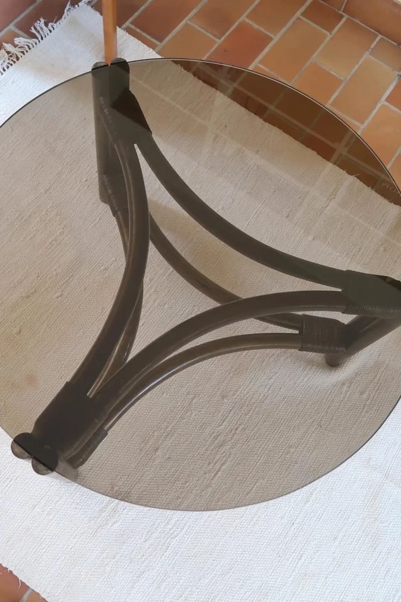 Round coffee table in rattan and smoked glass — 1970s