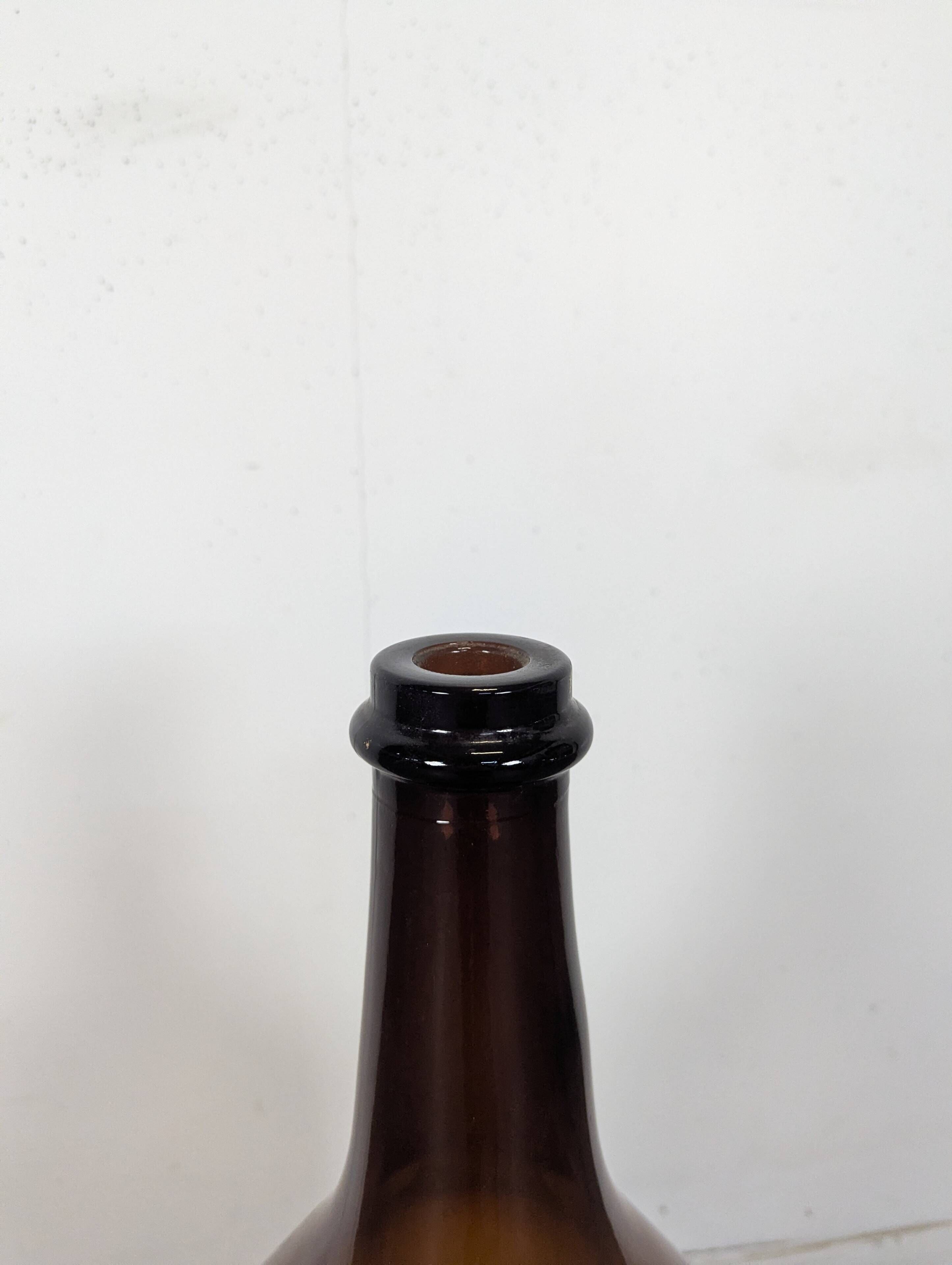 Large antique blown amber glass bottle