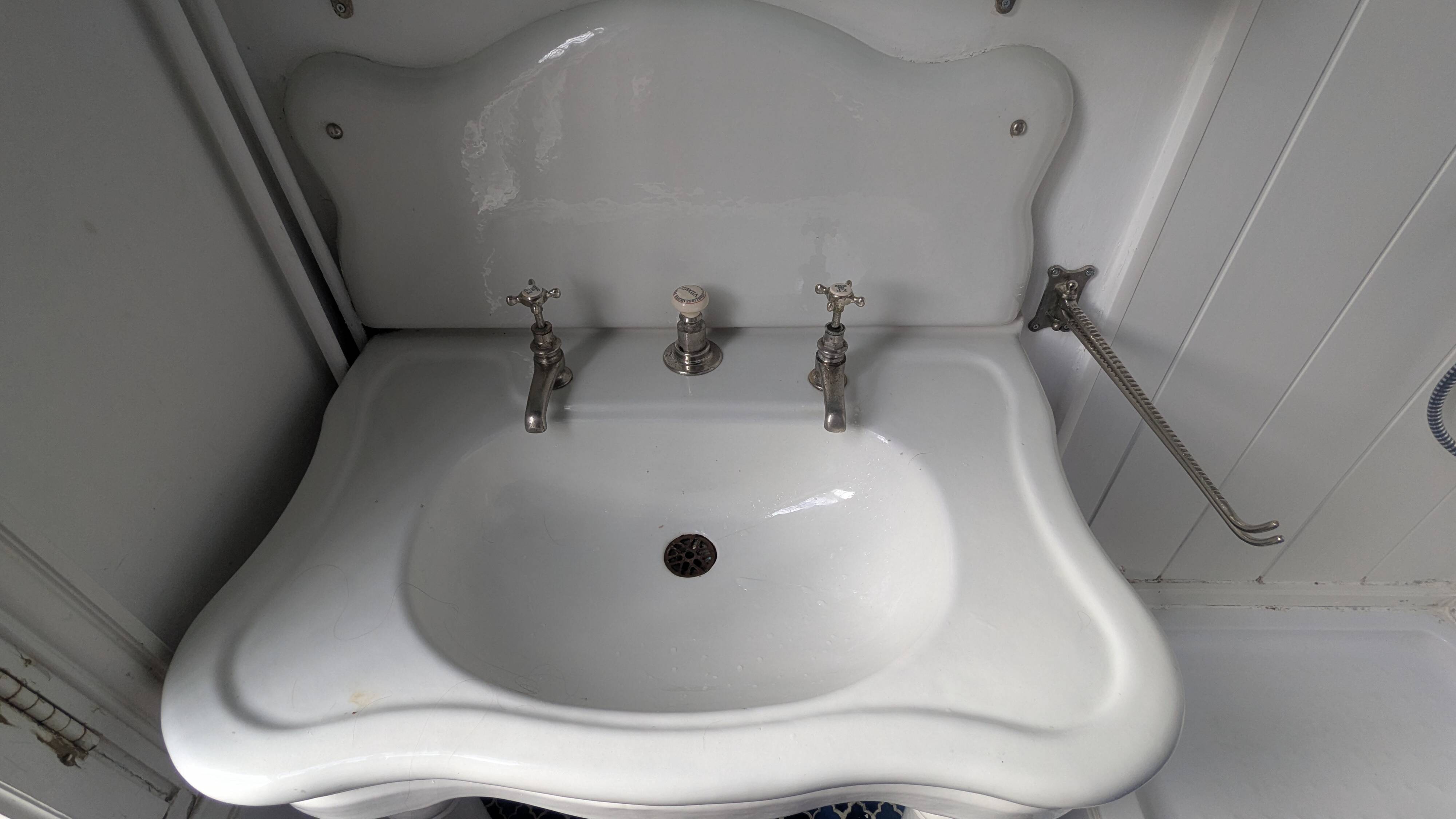 Set of a sink and its retro ceramic splashback.
