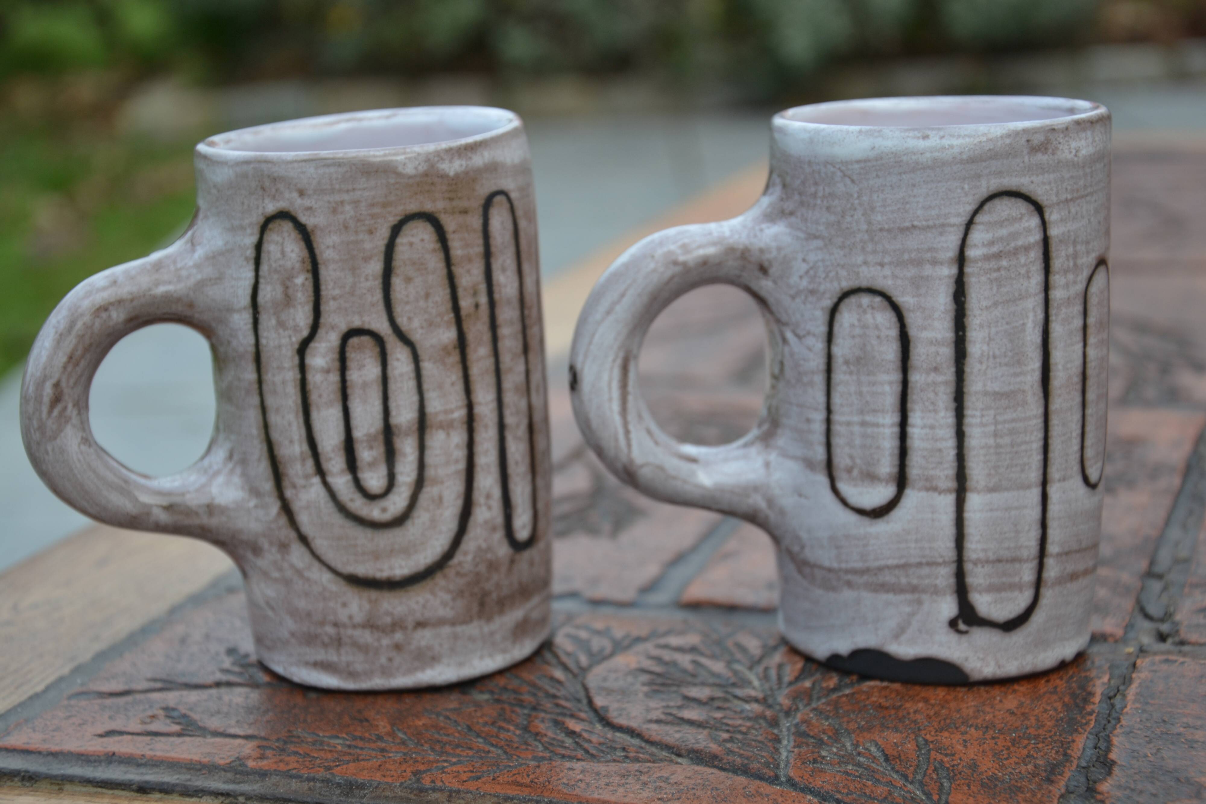 2 ceramic mugs signed db
