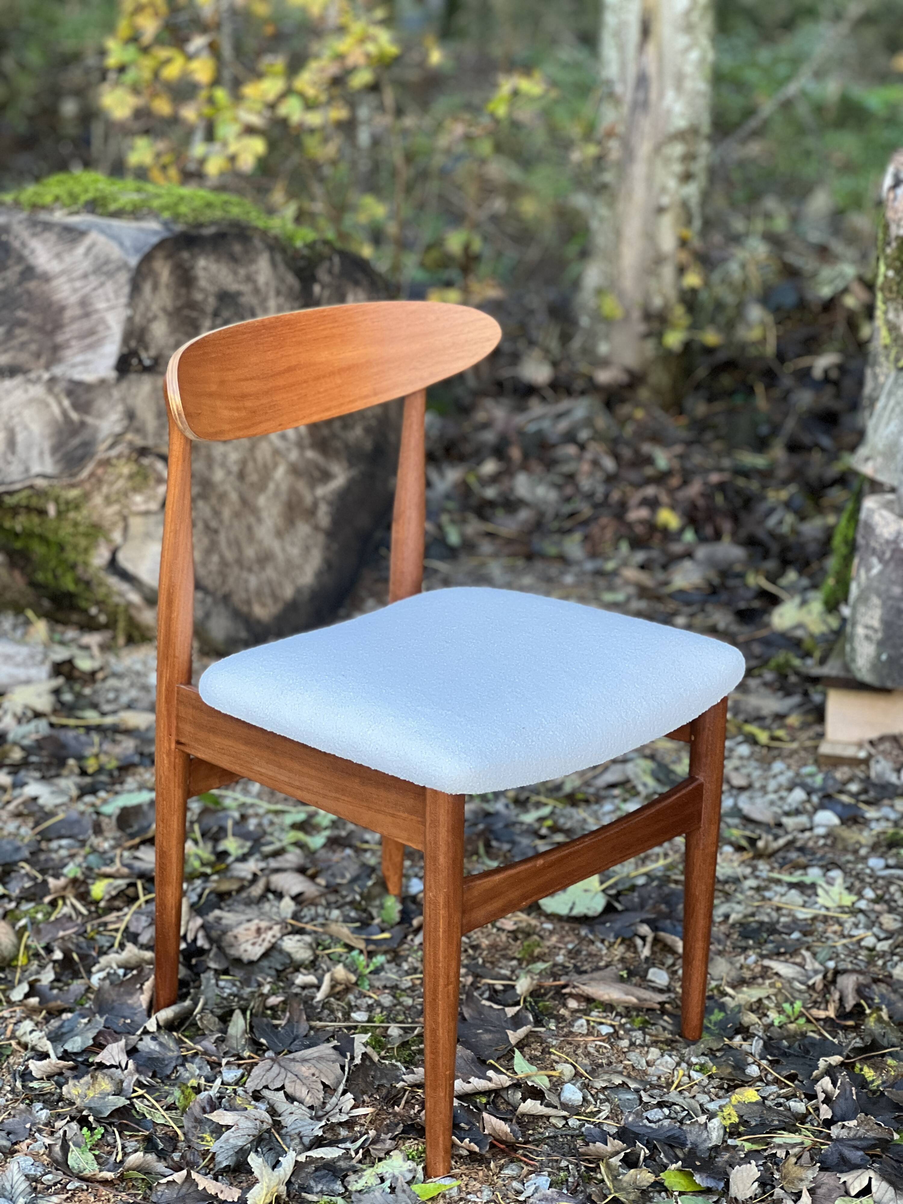 A set of GPlan chairs in teak with a white woolly fabric