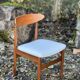 A set of GPlan chairs in teak with a white woolly fabric