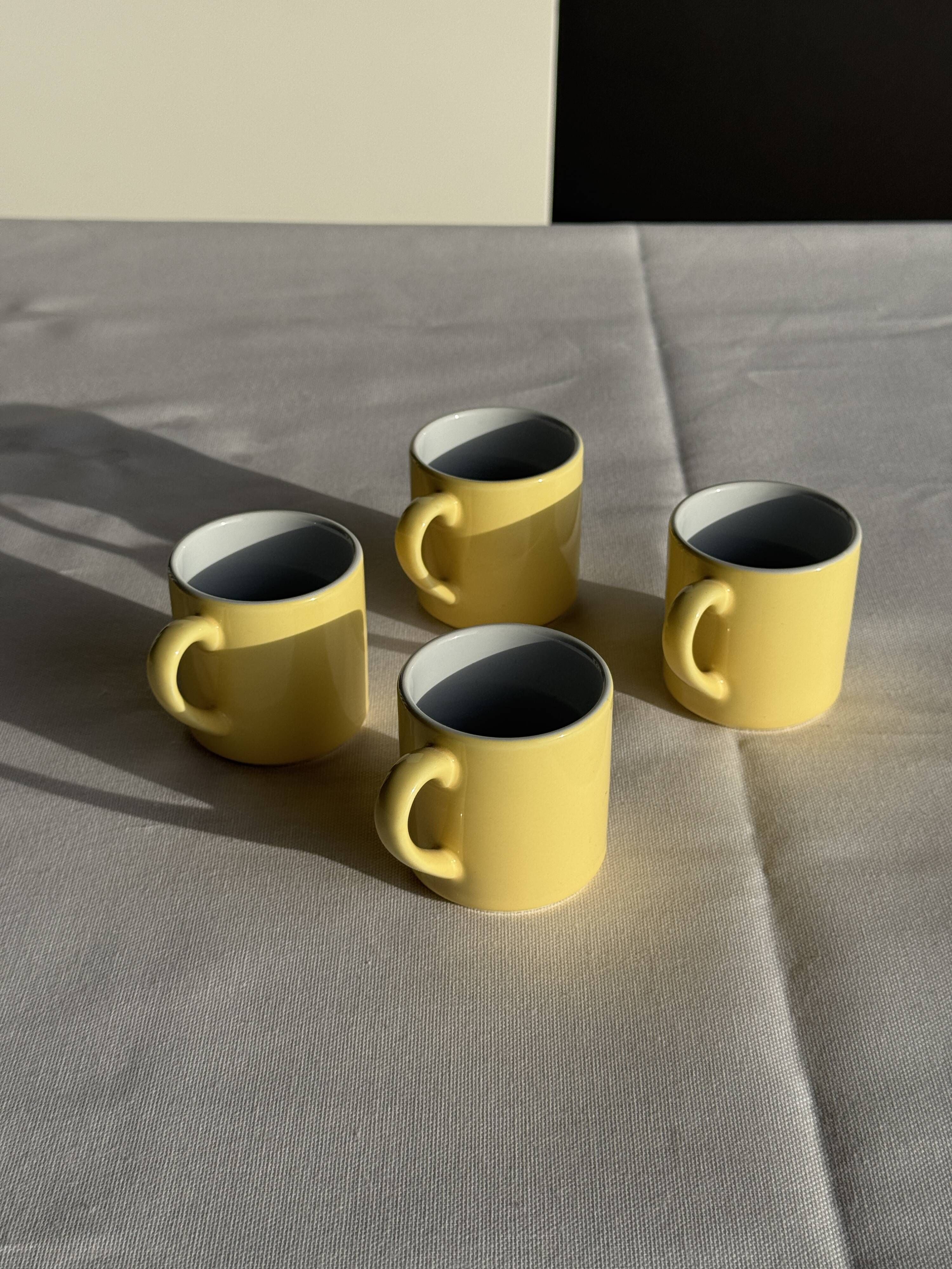 Set of 4 vintage yellow Italian espresso cups and saucers.