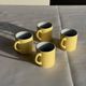 Set of 4 vintage yellow Italian espresso cups and saucers.