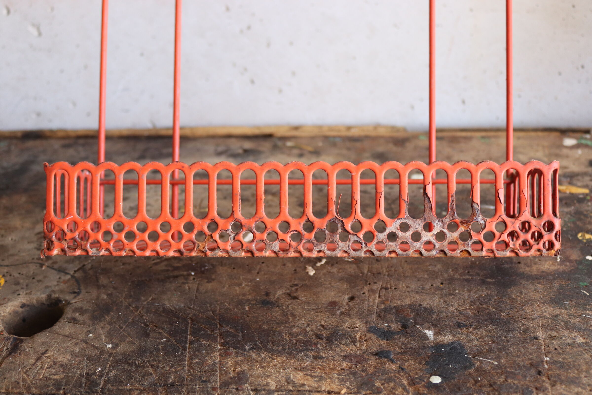 Vintage shelf in red openwork metal