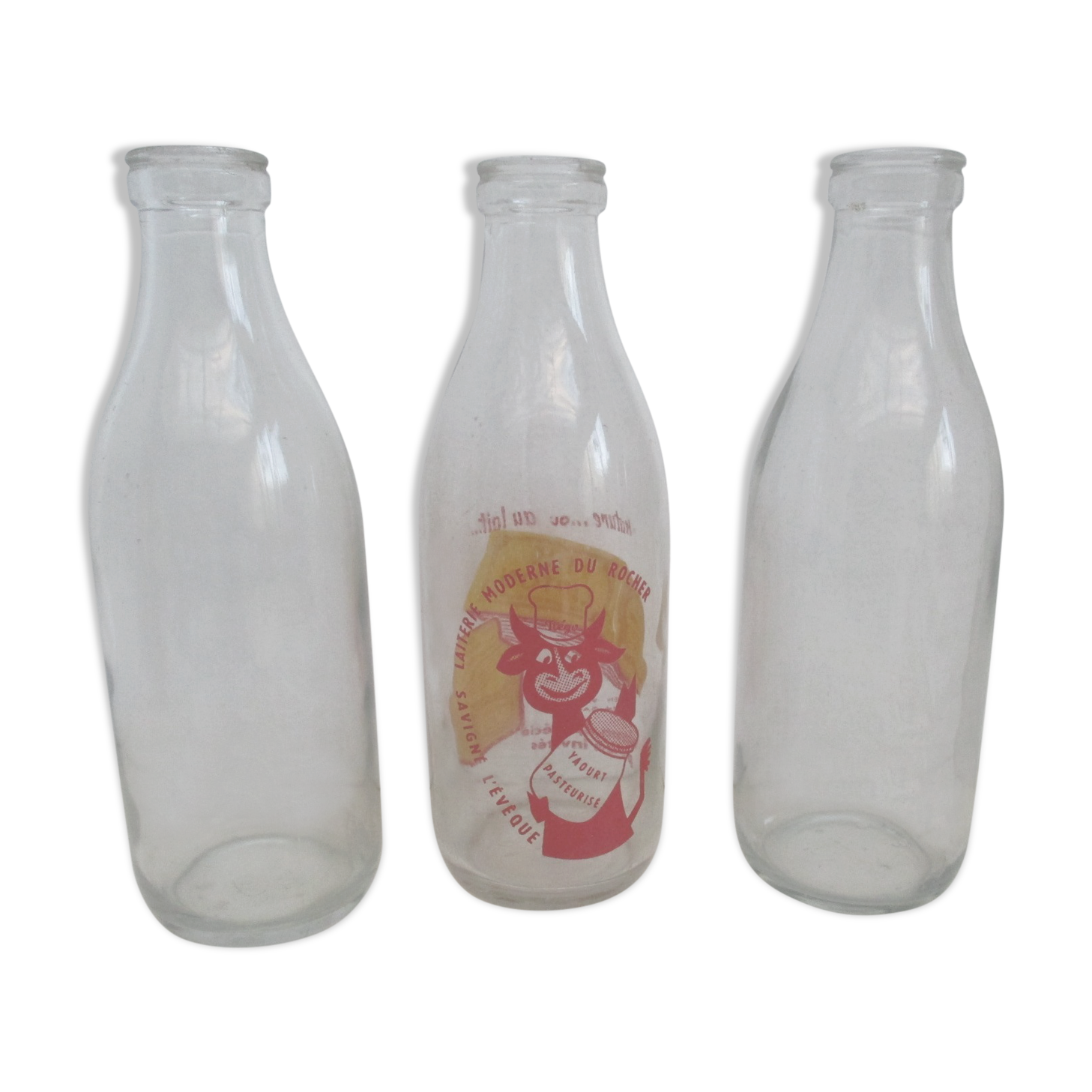 Three vintage glass milk bottles.