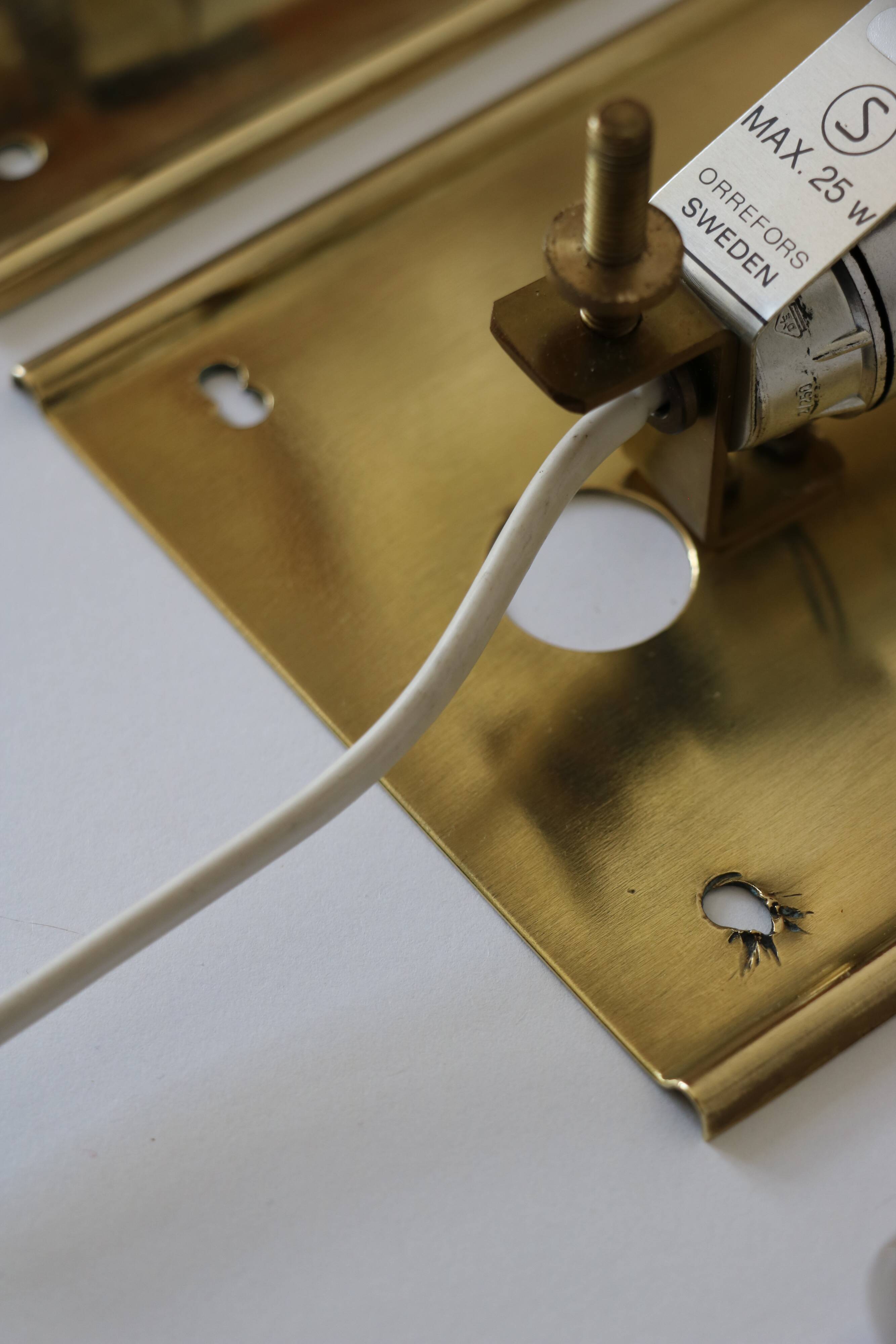 Pair of glass and brass wall lights by Carl Fagerlund for Orrefors.