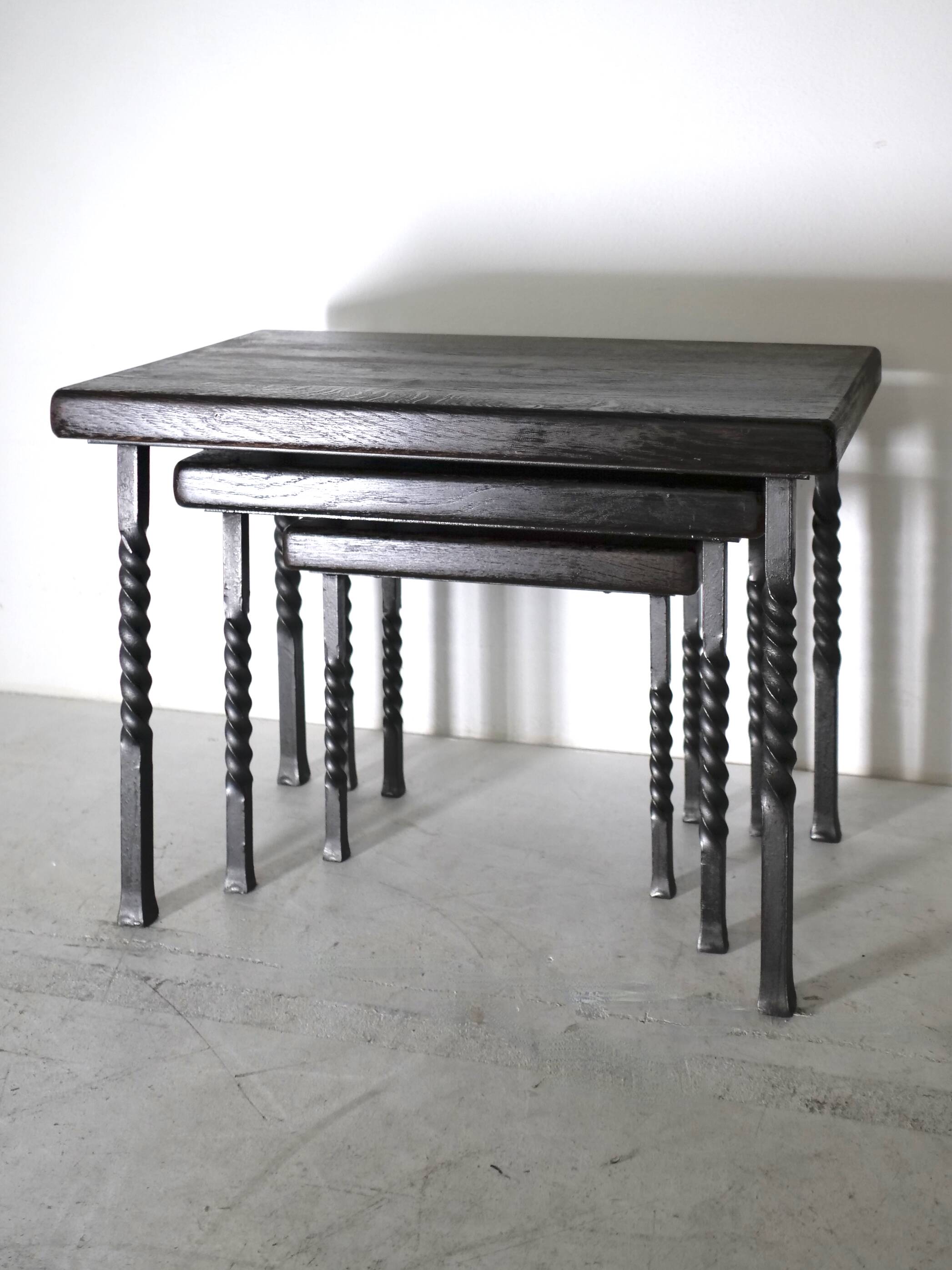 Brutalist nesting table in ebonized oak and wrought iron