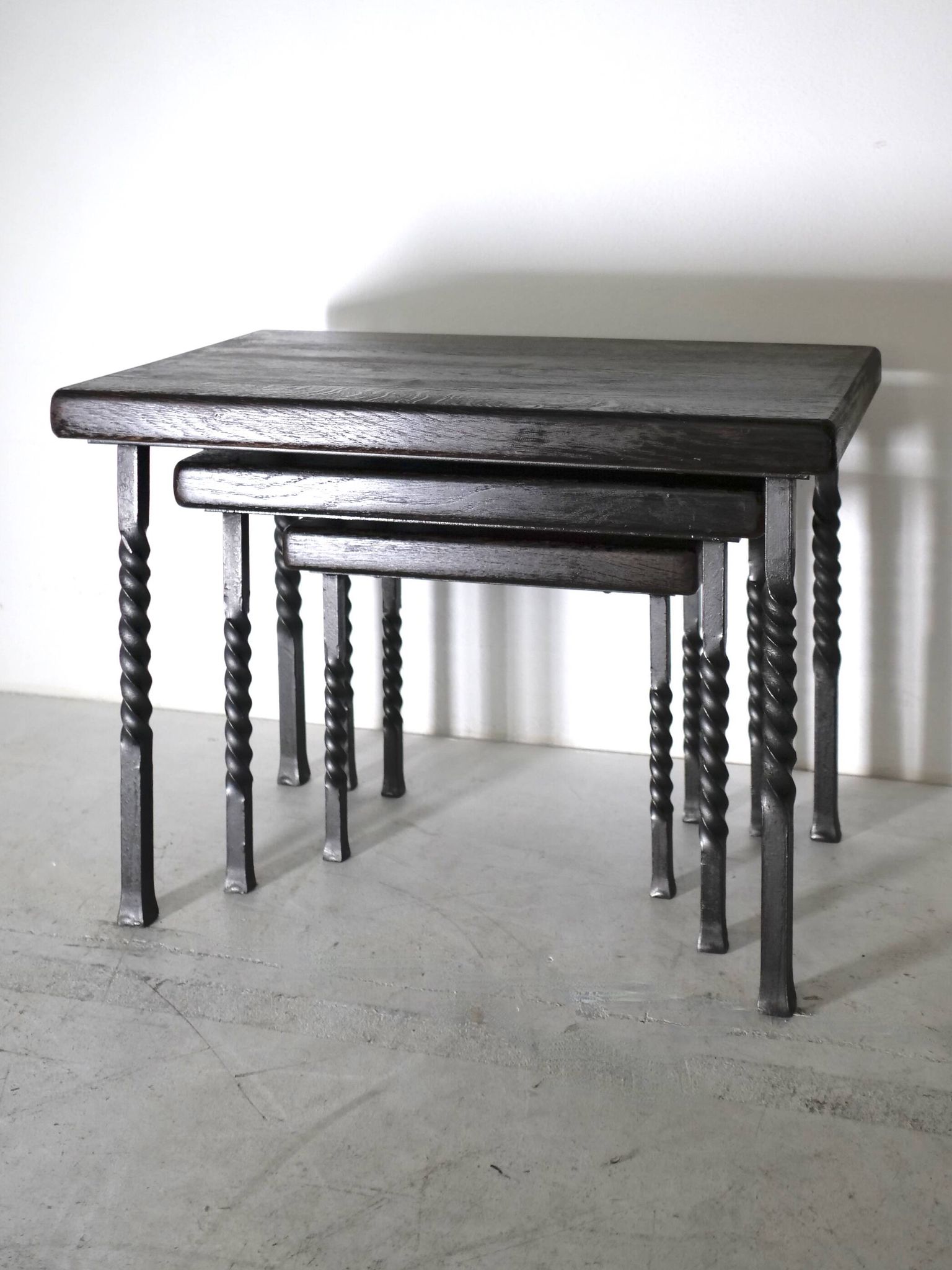 Brutalist nesting table in ebonized oak and wrought iron