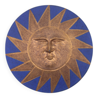Relief mural signed in ceramic, sun with blue and gold face, 1990s.