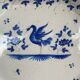 Antique octagonal plate in blue and white pottery with bird decoration.