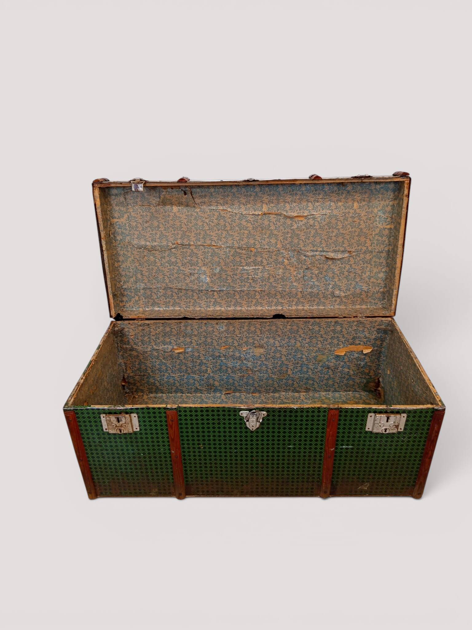Vintage wooden and metal green travel trunk, circa 1930.