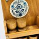 Wall-mounted egg cup holder and wooden utensil holder.