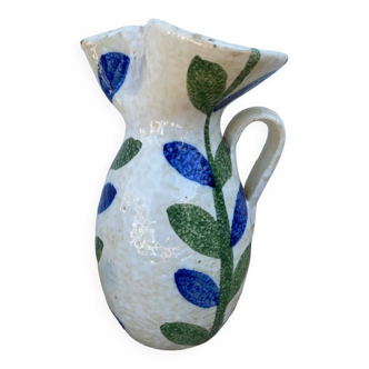 Large white pitcher with green and blue plant pattern