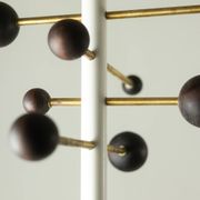 Coat rack from floor to ceiling in lacquered metal and brass. Contemporary.