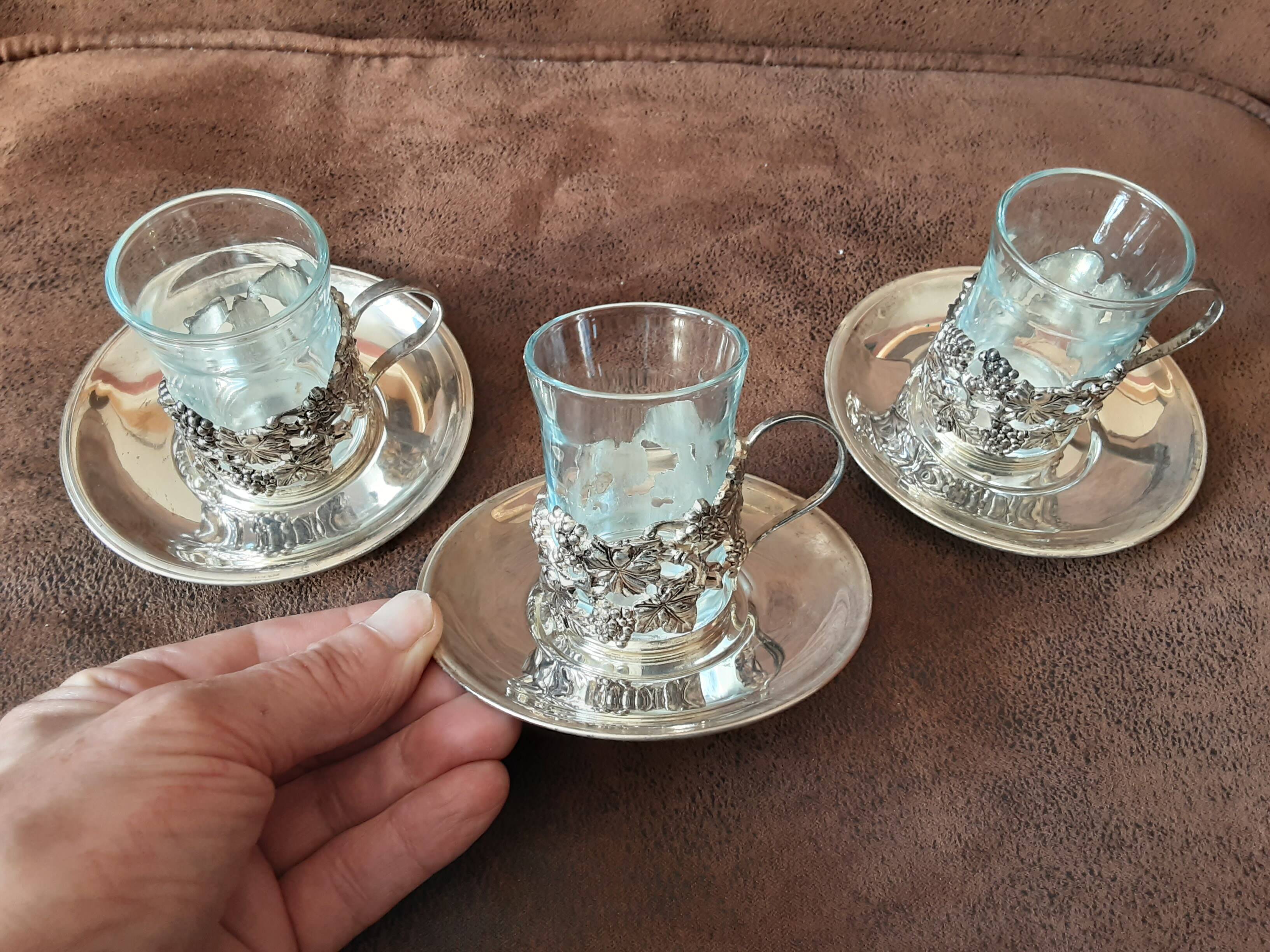 Set of 3 small metal glasses and saucers