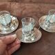 Set of 3 small metal glasses and saucers