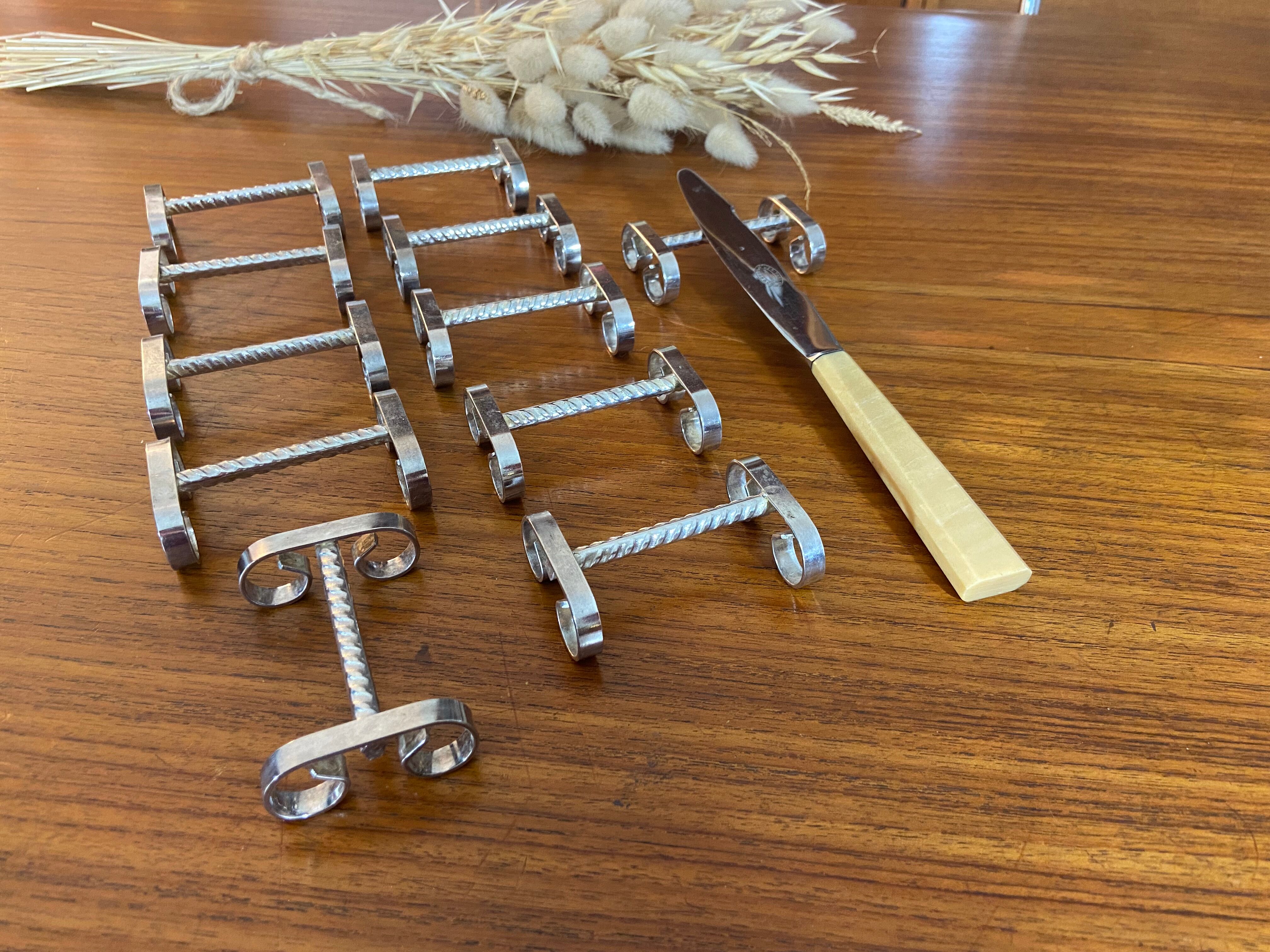 Set of 11 silver-plated metal knife holders, 1960