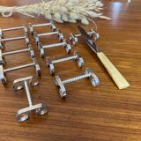 Set of 11 silver-plated metal knife holders, 1960