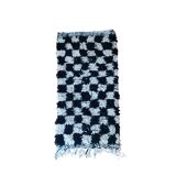 Small black tile Berber rug