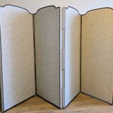 Vintage white faux leather screen with four studded panels, elegant decor.