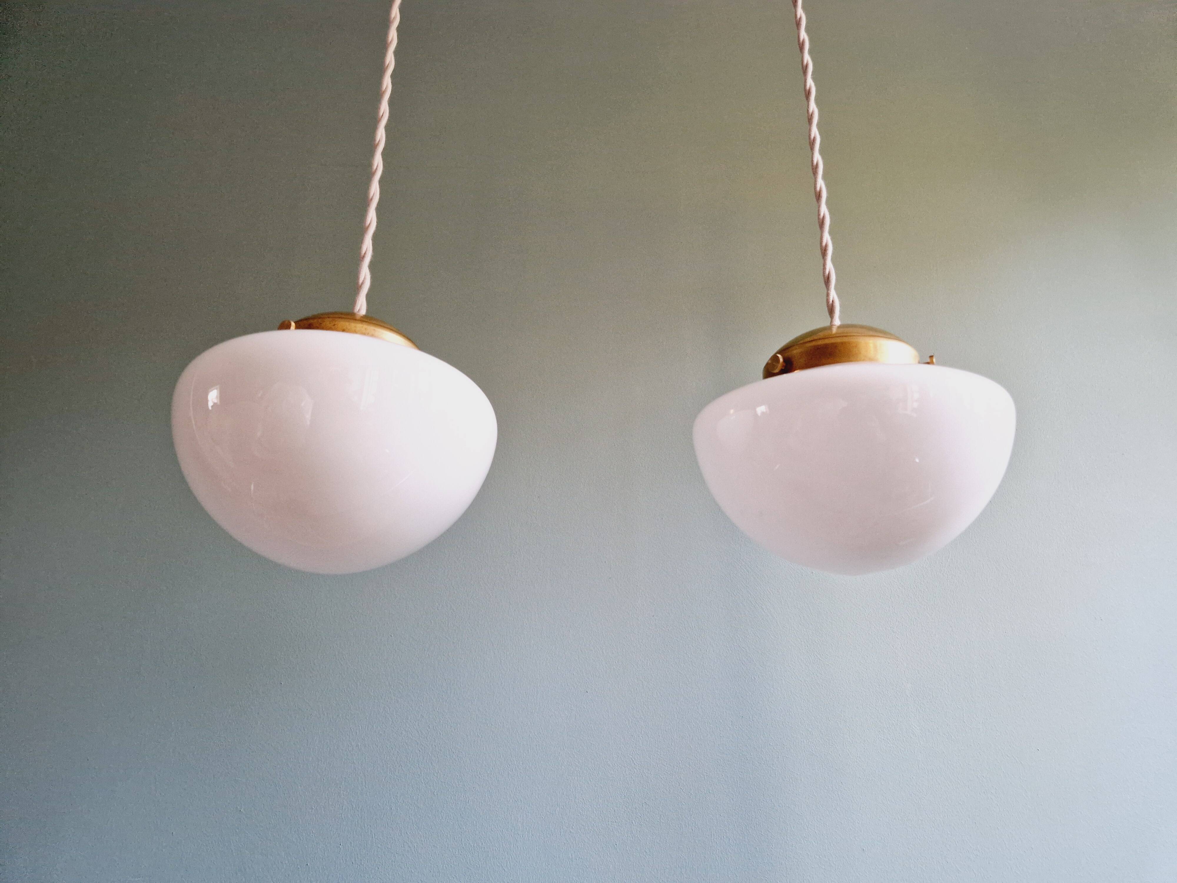 Duo of Art Deco suspensions in white opaline, 1920s-30s