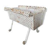 Wrought iron planter hides perforated sheet metal pot