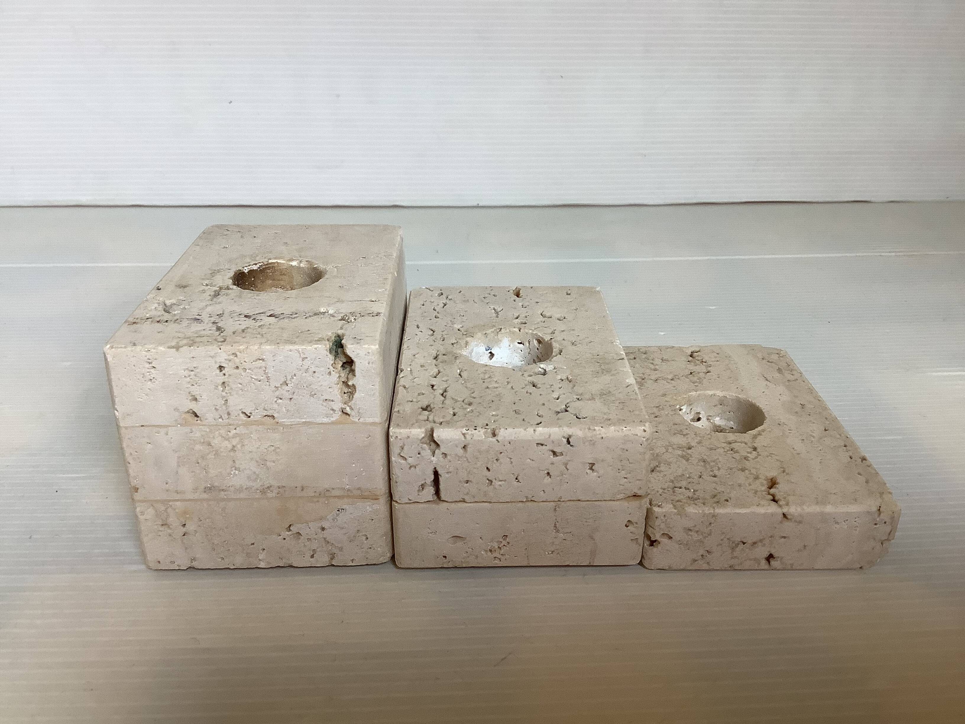 Trio of travertine candlesticks