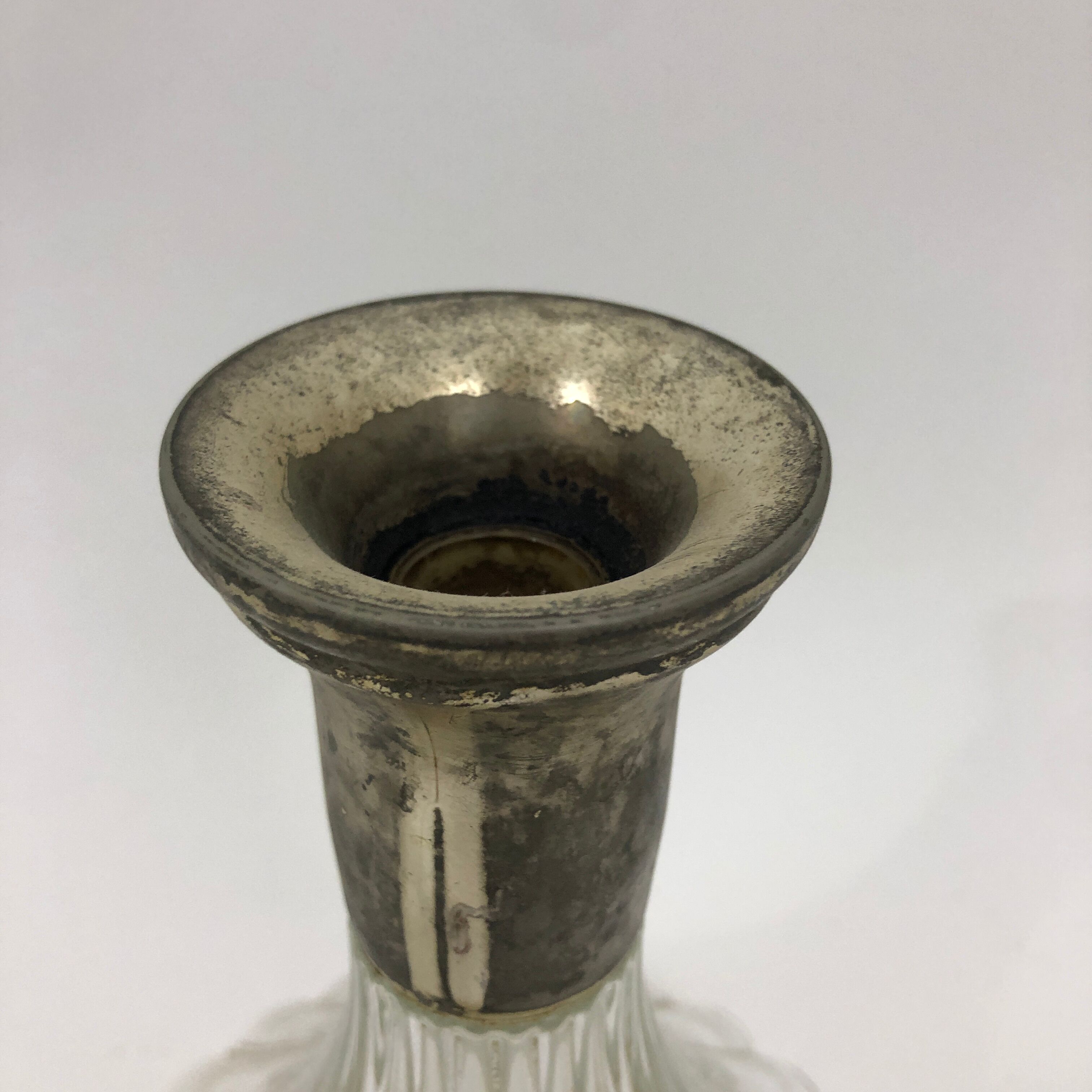 Large glass decanter and tin ring