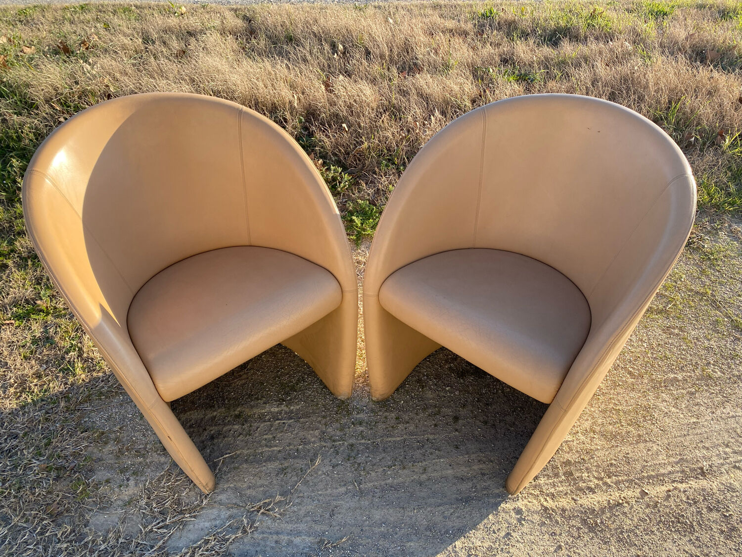 Pair of designer leather armchairs
