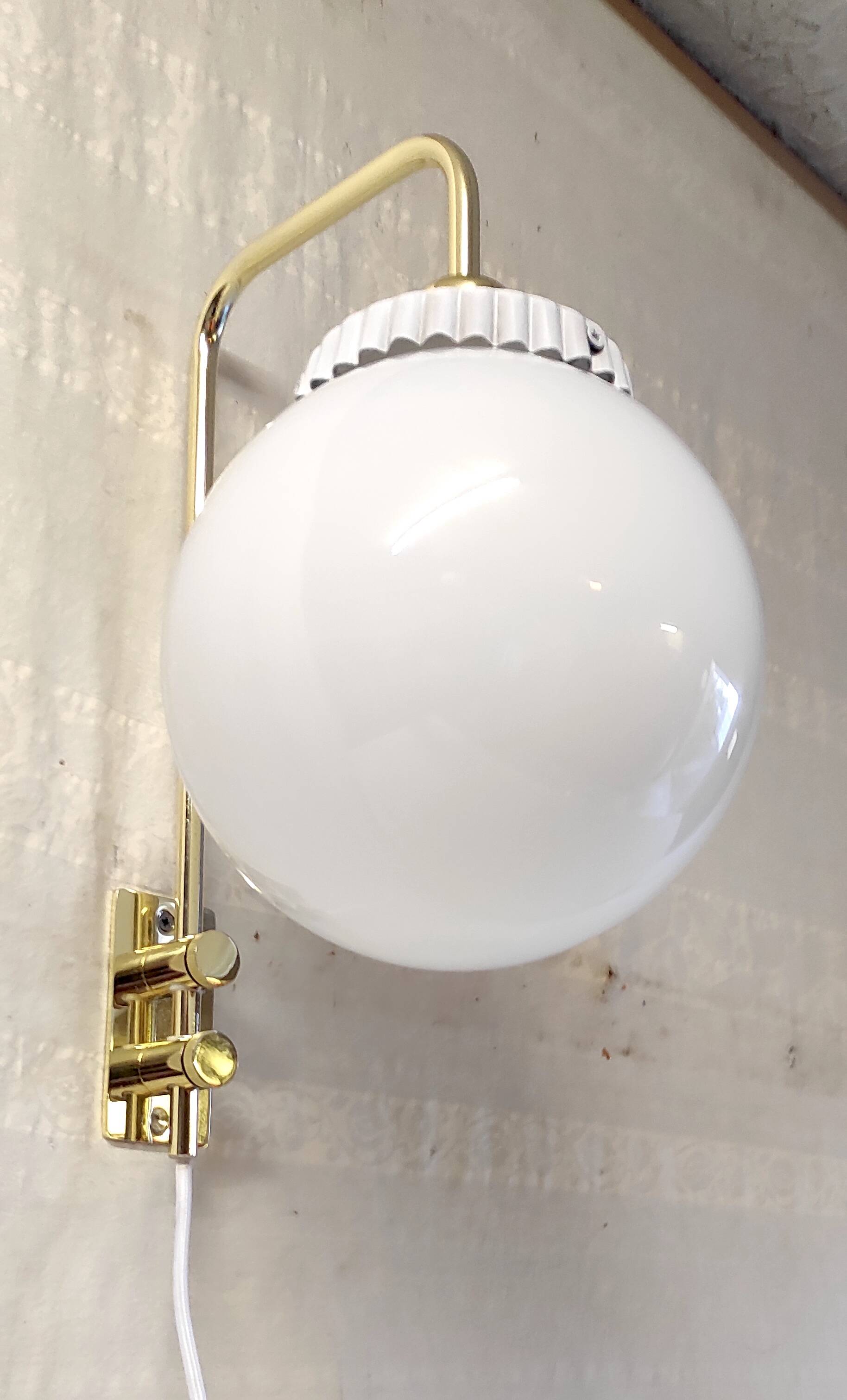 Opaline glass globe wall sconce with a gilt metal bracket - mid-20th century