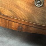 English commode from the George III Regency period, bombe shape in mahogany veneer.