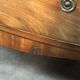 English commode from the George III Regency period, bombe shape in mahogany veneer.