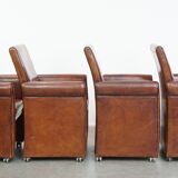 Vintage set of 4 sheepskin leather dining chairs on castors