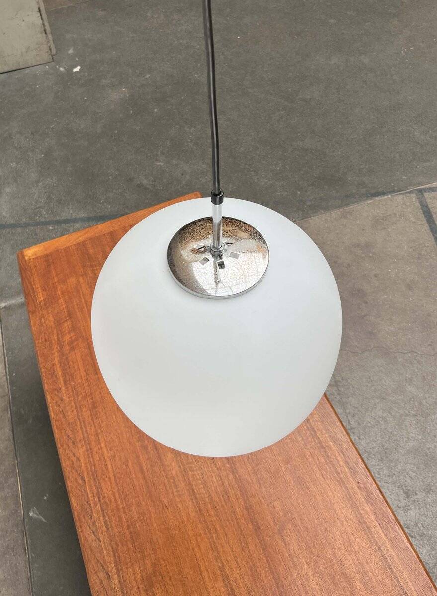 Minimalist suspended glass ball lamp from the vintage German space age by Glashütte Limburg, 1970s.