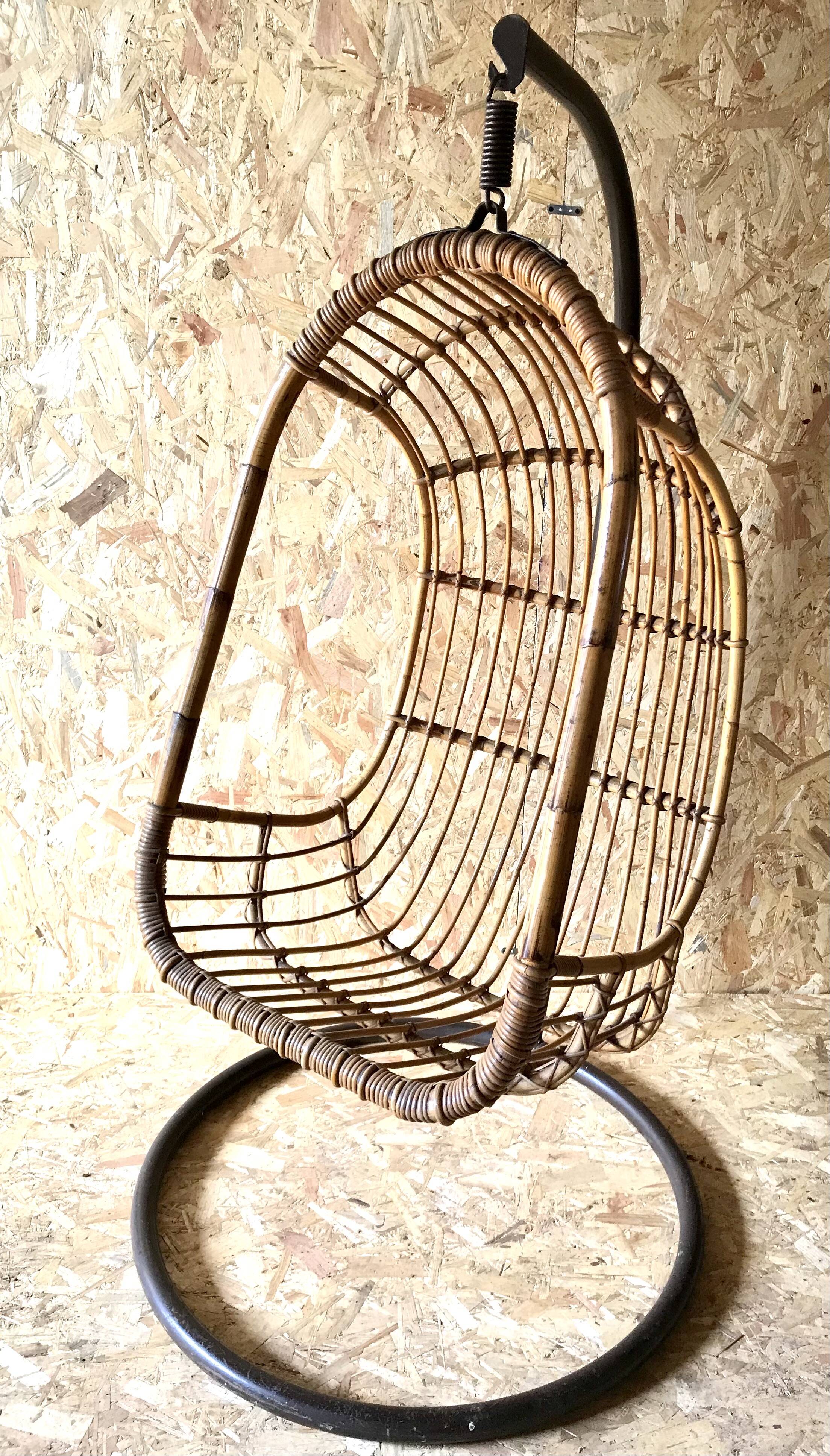 Vintage rattan hanging chair with its stand.