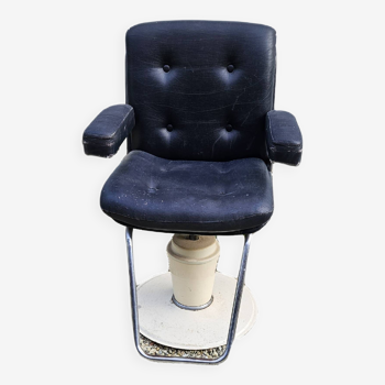 Vintage hairdresser's chair in black imitation leather