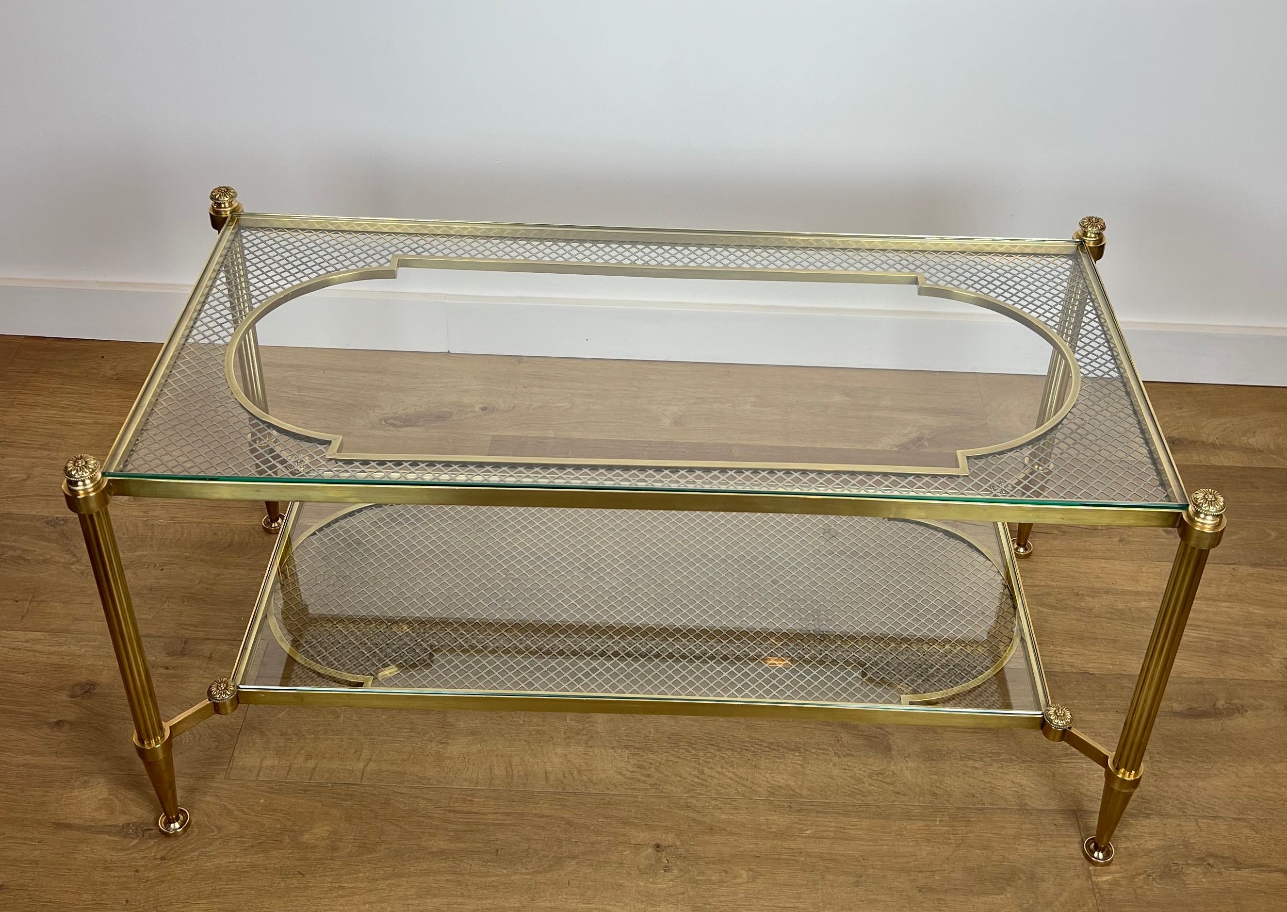 Rare bronze, brass, and steel mesh coffee table with a double glass top resting on a brass mesh. French work by Jansen