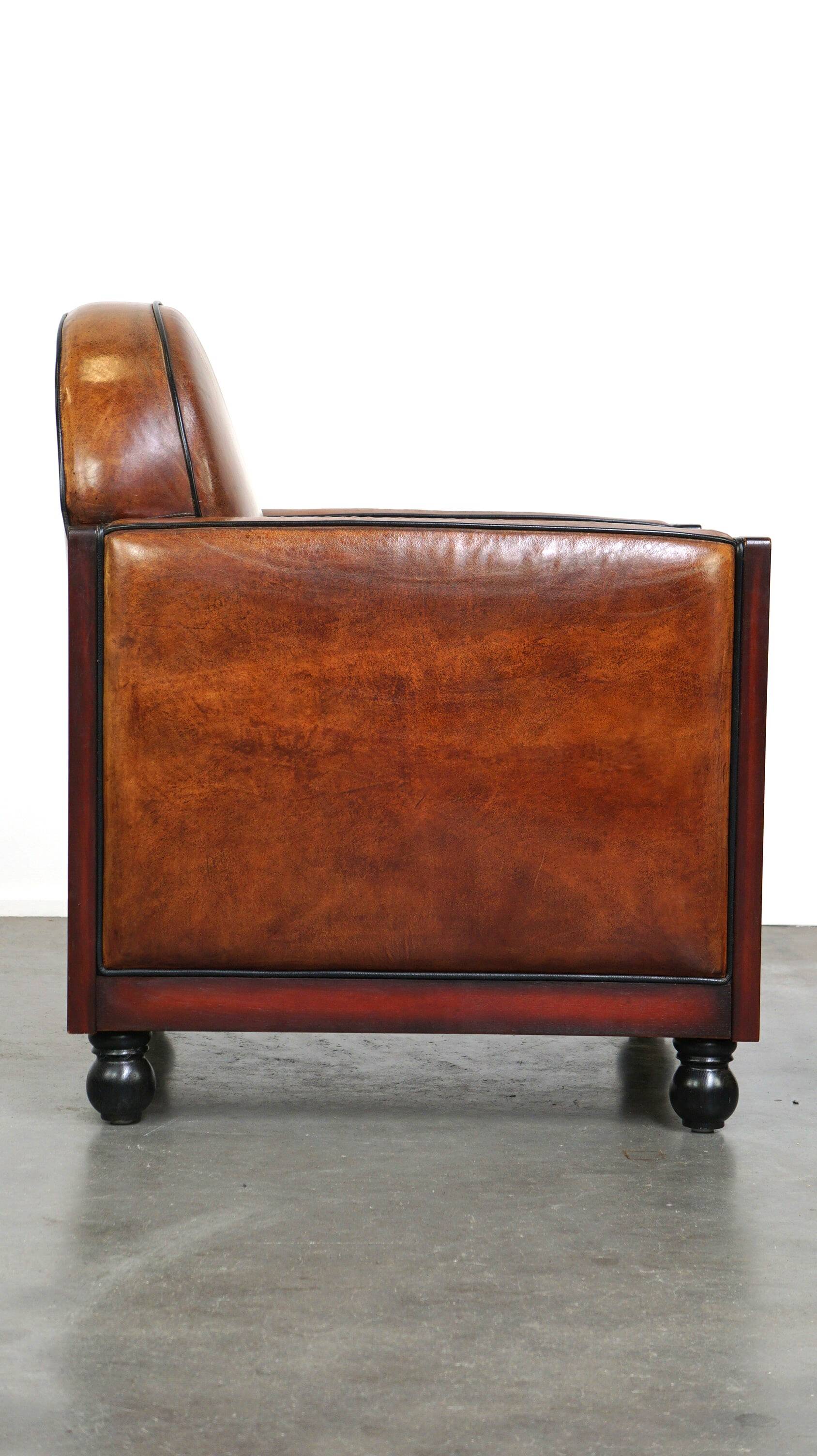 Sheepskin Art Deco design armchair with wood and beautiful cognac-colored leather